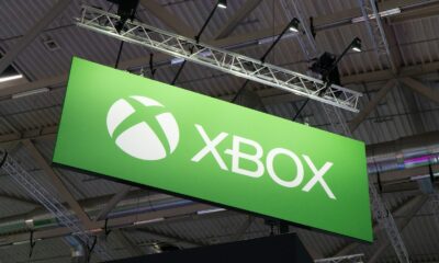 a large green sign hanging from the ceiling of a building